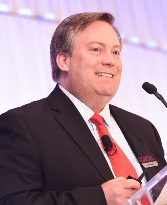 Chad Massie, Principal of M2 Group, speaking at a podium